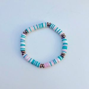 Handcrafted pink, white, and teal, beaded bracelet.